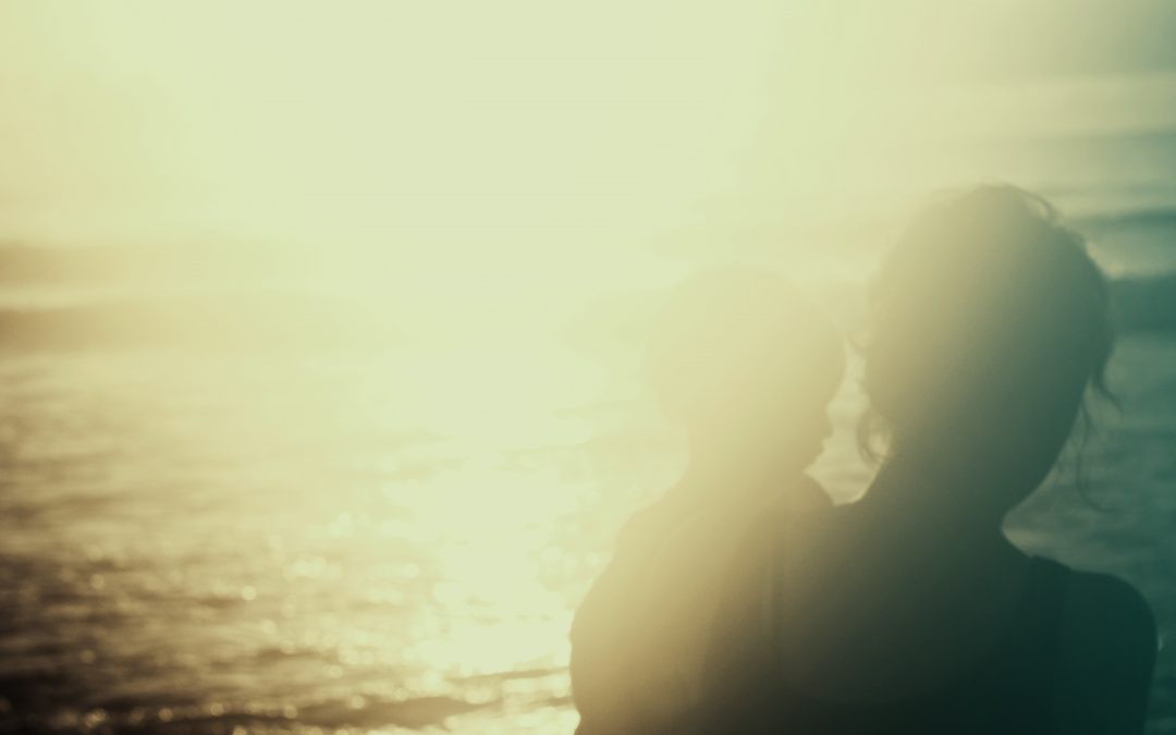 blurry photo of mother and child at the beach